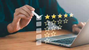 A hand checking a box next to a five-star rating on a virtual checklist over a laptop, symbolizing a successful online review and reputation management.